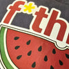 Sticker with watermelon design and partially visible text on a dark background