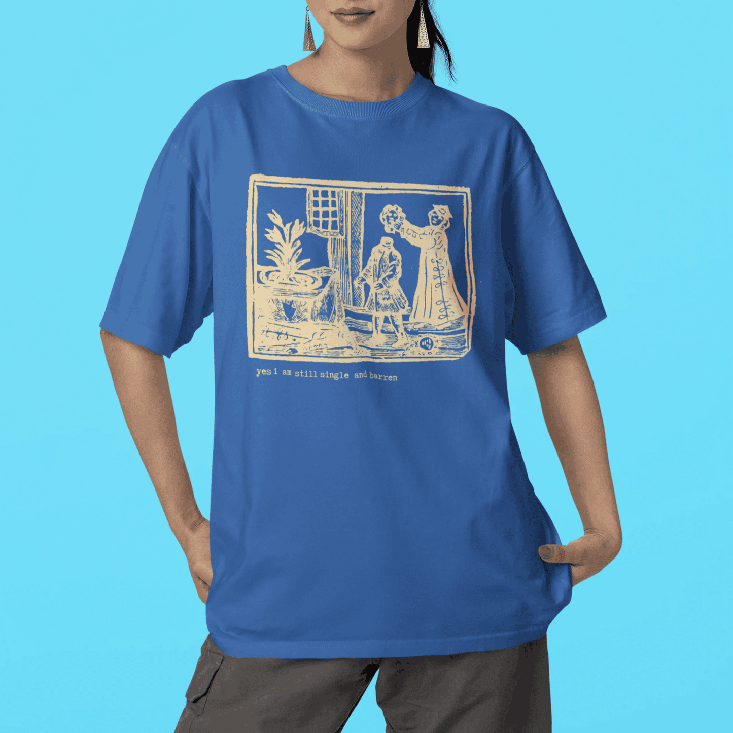 Woman wearing a bright royal blue t-shirt with a graphic design saying "yes I am single and barren."