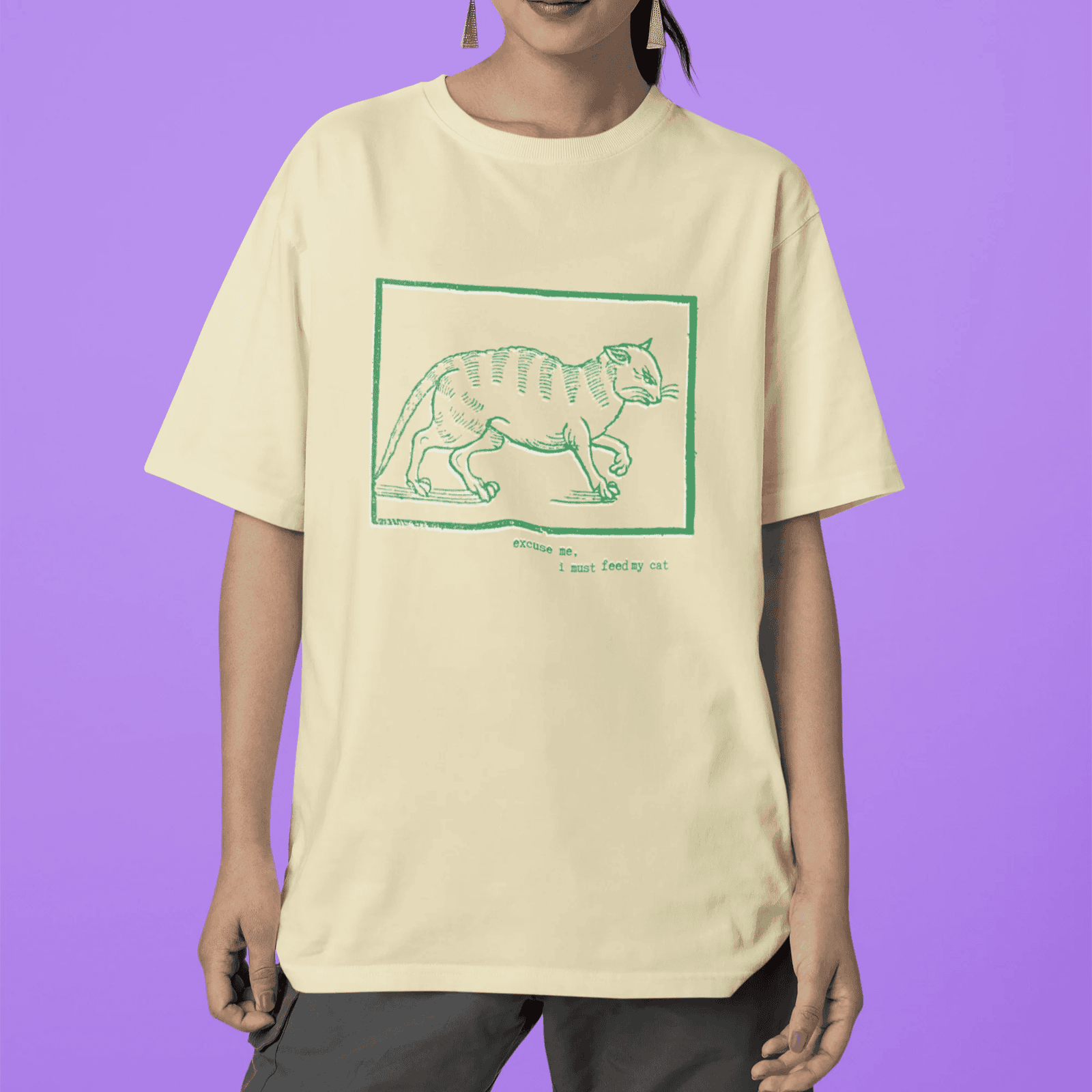 Excuse me, I must feed my cat - woman wearing oversized lemonade staple t-shirt with medieval woodcut style illustration of a