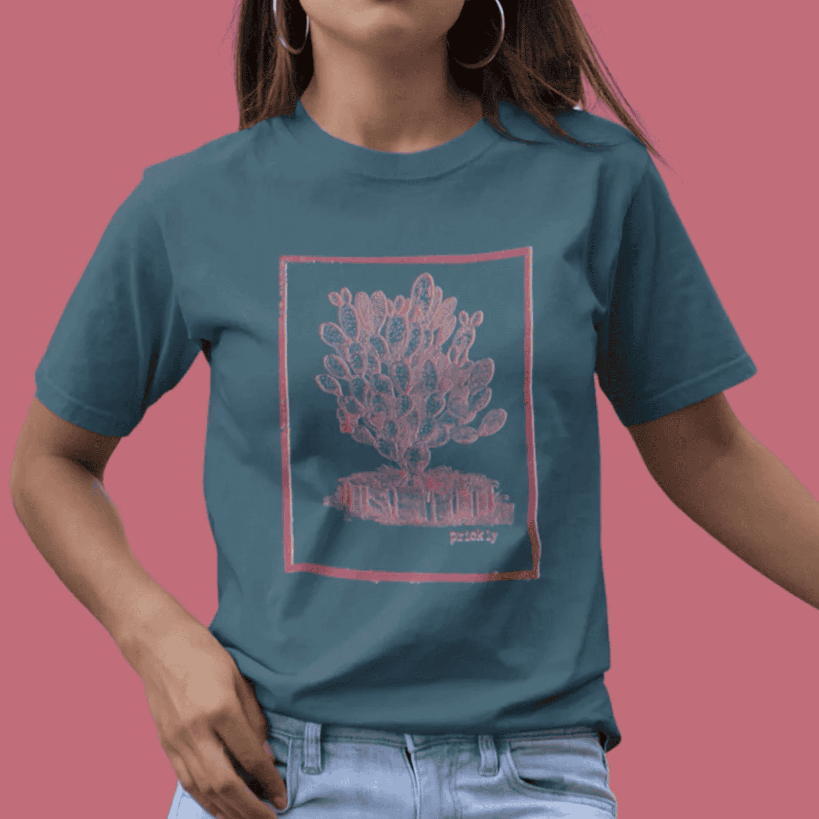 Woman wearing petrol blue classic tee with prickly design.