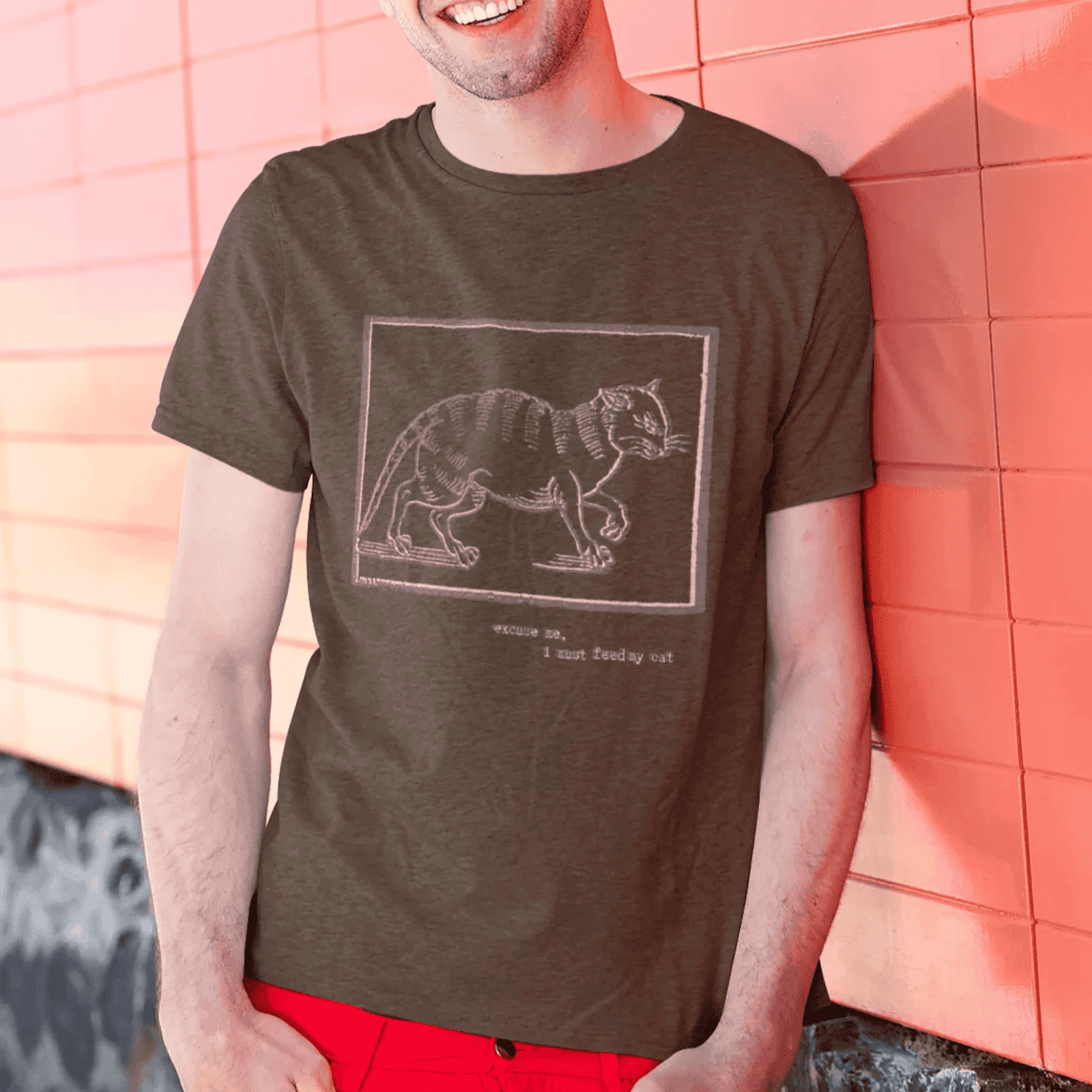 Excuse me, I must feed my cat - man wearing dark chocolate staple t-shirt with medieval woodcut style illustration of a witch