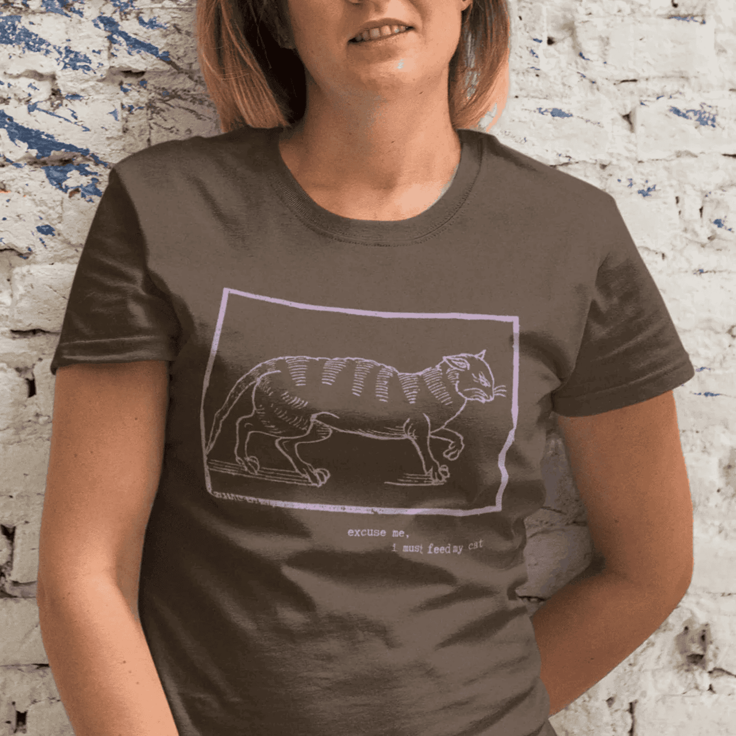 Excuse me, I must feed my cat - woman wearing dark chocolate staple t-shirt with medieval woodcut style illustration of a wit